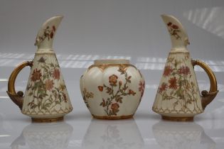 A pair of Royal Worcester porcelain ewers decorated with flowers and leaves number 1361 together