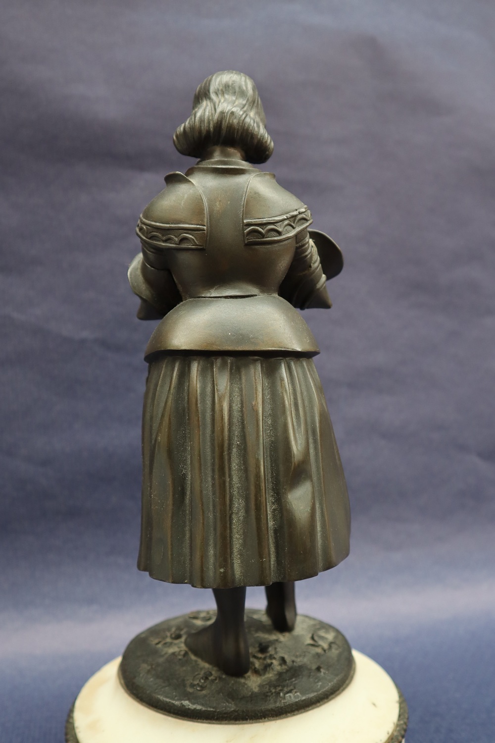 A bronze figure of Joan of Arc, with head bowed clutching a sword, on a circular marble base, 27. - Image 4 of 8