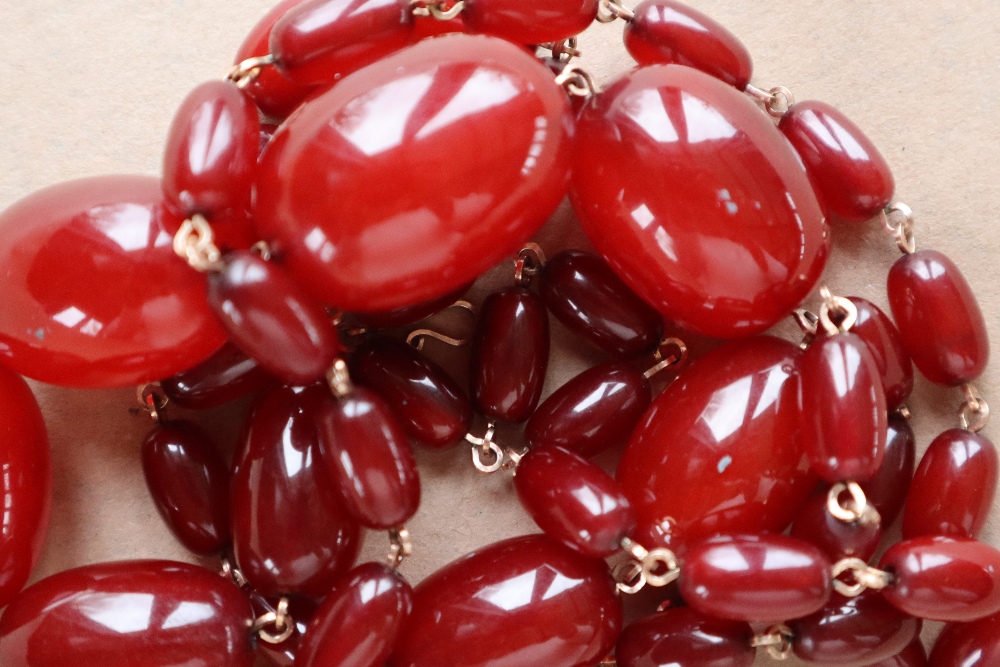 A string of cherry amber / bakelite beads,