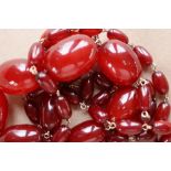 A string of cherry amber / bakelite beads,