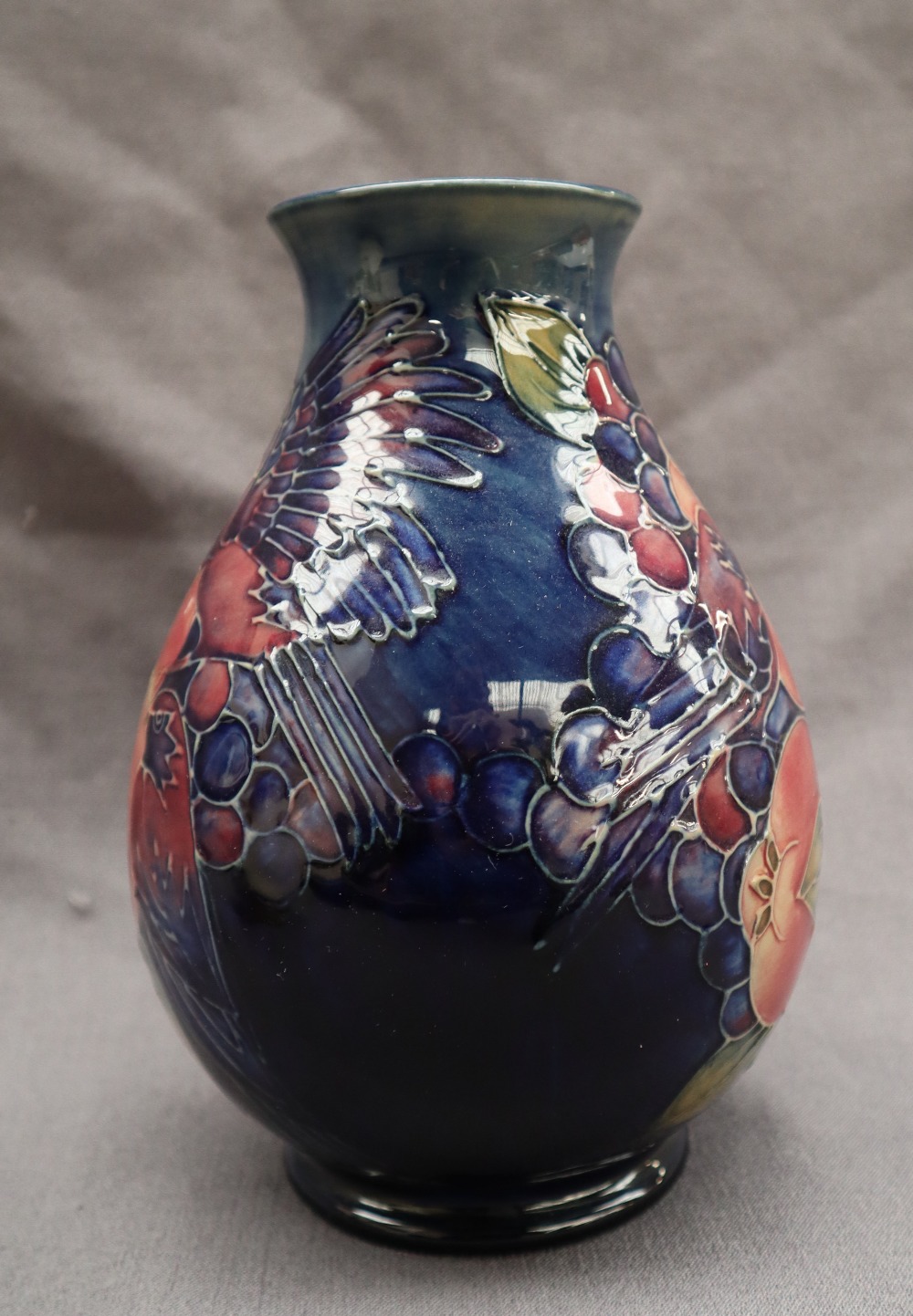 A Moorcroft pottery vase decorated with birds and fruit to a royal blue ground, - Image 3 of 9