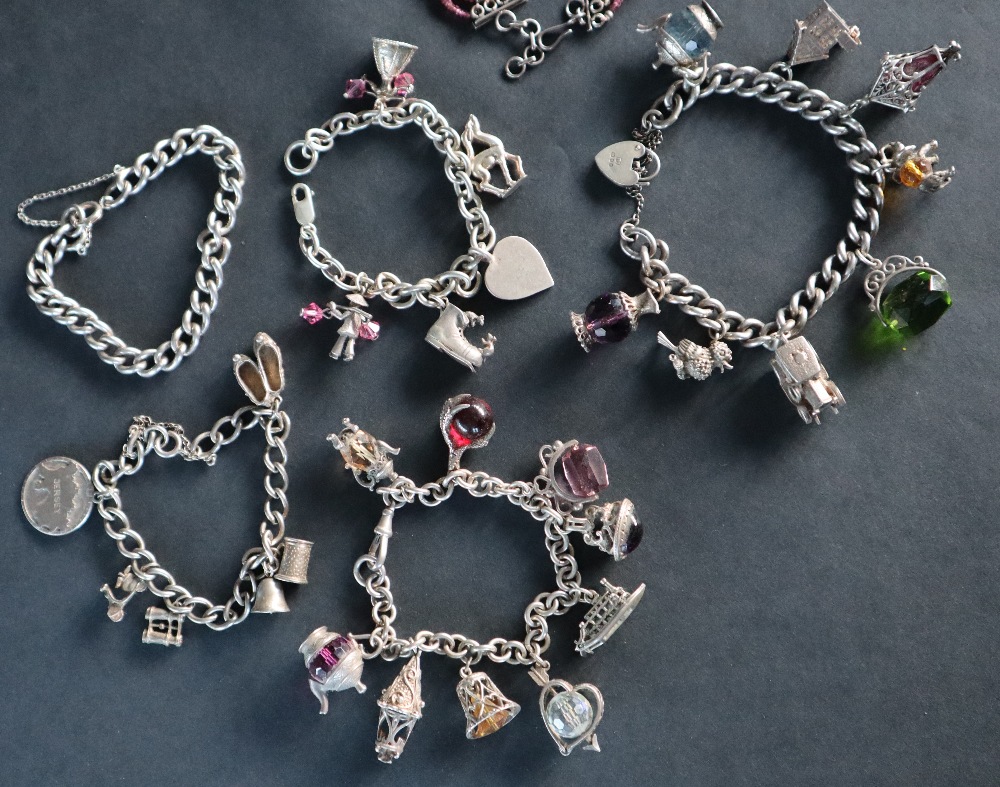 A silver charm bracelet set with numerous charms including a carriage, bird, - Image 2 of 6