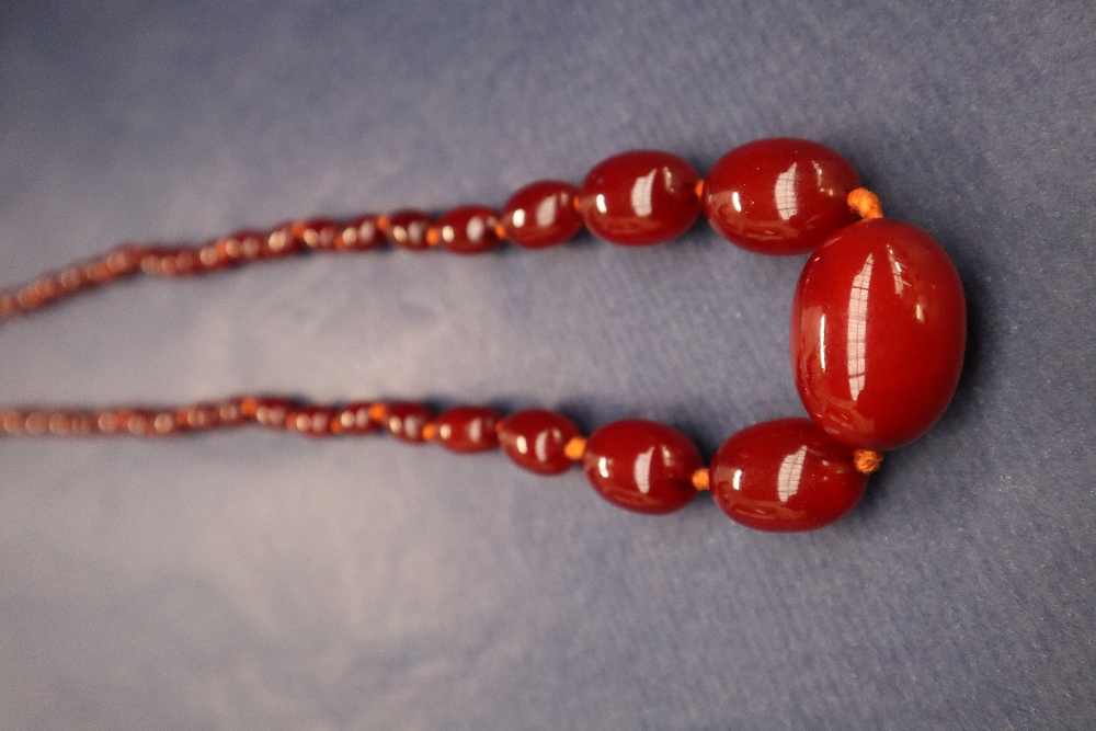 A cherry amber / bakelite beaded necklace, with graduating beads varying in size from 30mm to 10mm, - Image 2 of 9