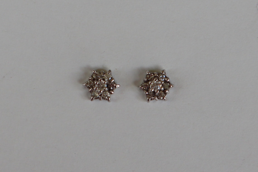 A pair of diamond stud cluster earrings,