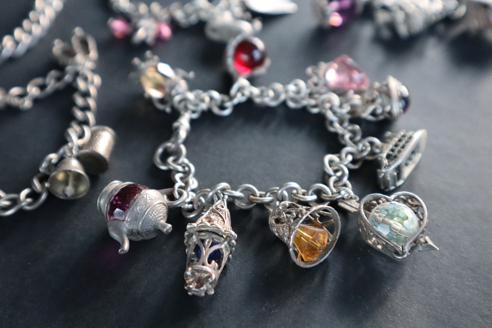 A silver charm bracelet set with numerous charms including a carriage, bird, - Image 3 of 6