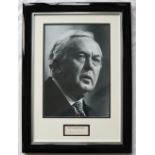 A black and white photograph montage of Harold Wilson with an autopen signed card "By The