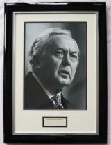 A black and white photograph montage of Harold Wilson with an autopen signed card "By The