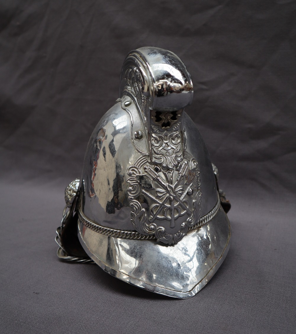 A chrome plated Merryweather type Fireman's helmet with dragon decorated comb,