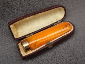 A 9ct gold mounted amber cheroot cigar holder,