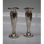 A pair of George V silver bud vases with a flared rim above a tapering body on a spreading foot,