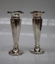 A pair of George V silver bud vases with a flared rim above a tapering body on a spreading foot,