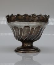 An Edward VII silver pedestal rose bowl, with a wheathusk scrolling border,