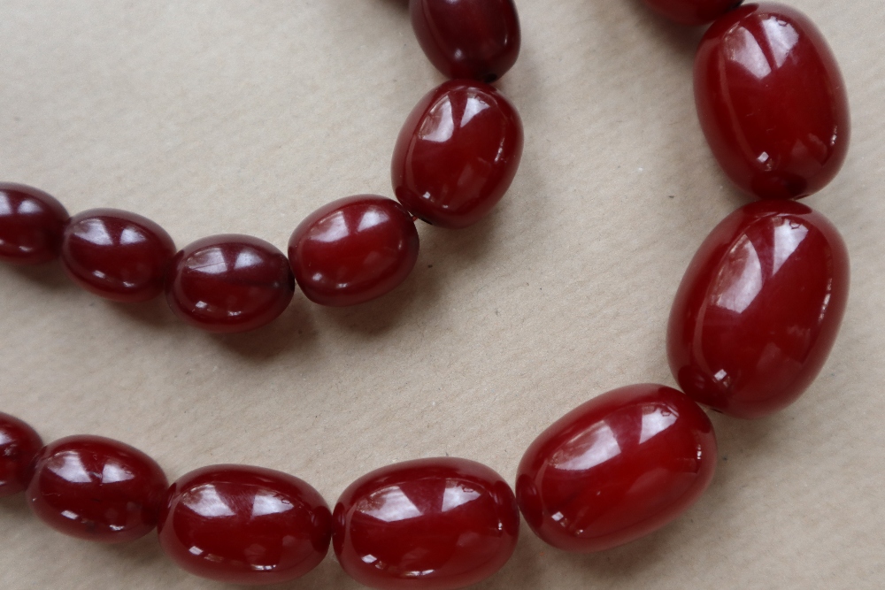 Two Cherry Amber / bakelite bead necklaces, ranging in size from 30mm to 10mm, 79cm long, - Image 3 of 12