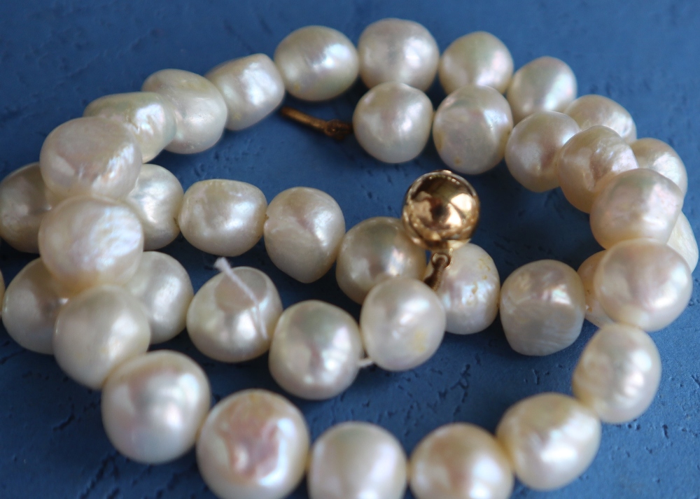 A pearl necklace with forty irregular pearls to a yellow metal ball clasp, 41. - Image 3 of 3