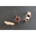 A 9ct gold dress ring set with a line of three garnets and two opals, size P 1/2,
