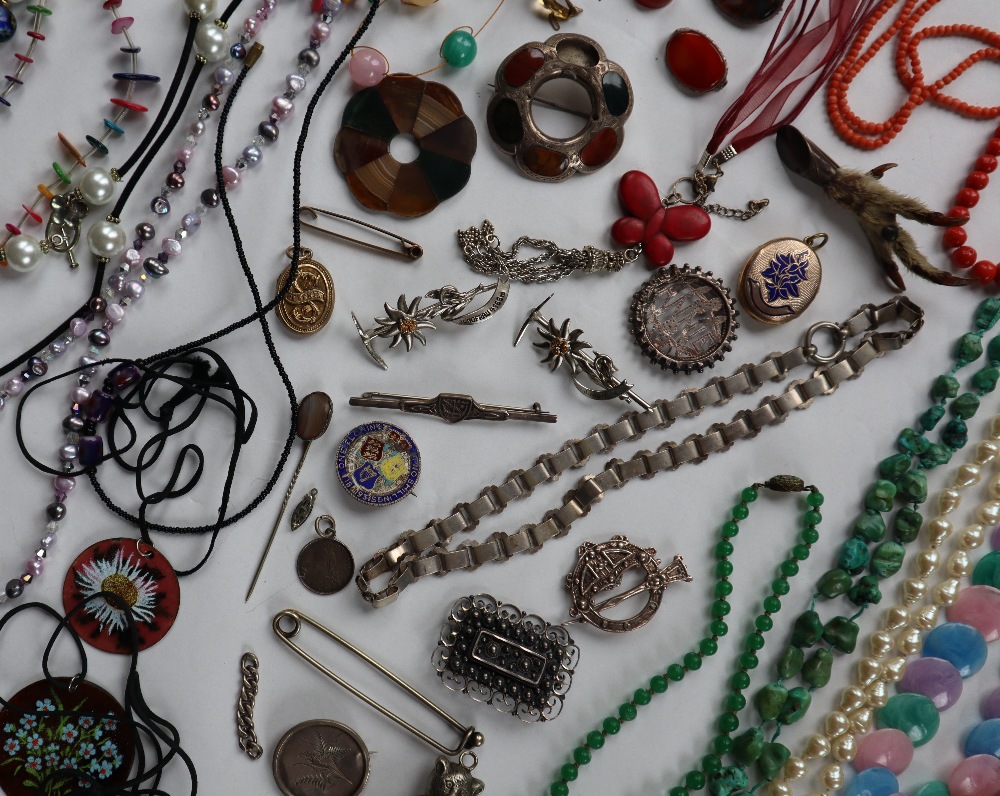 A large lot of assorted costume jewellery including Scottish hardstones, beaded necklaces,