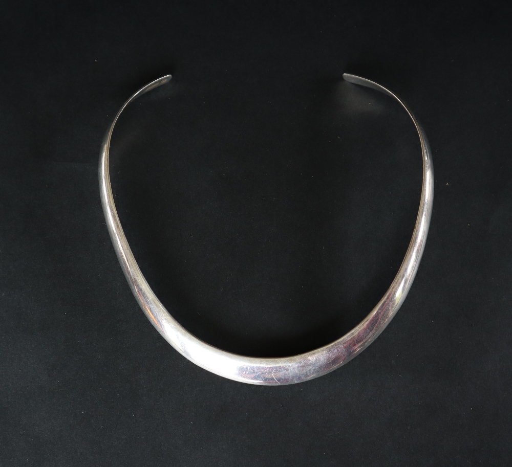 A silver torque necklet together with silver bangles,