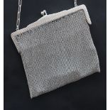 A George V silver mesh purse, with a crossover clasp and chain handle, import marks for London,