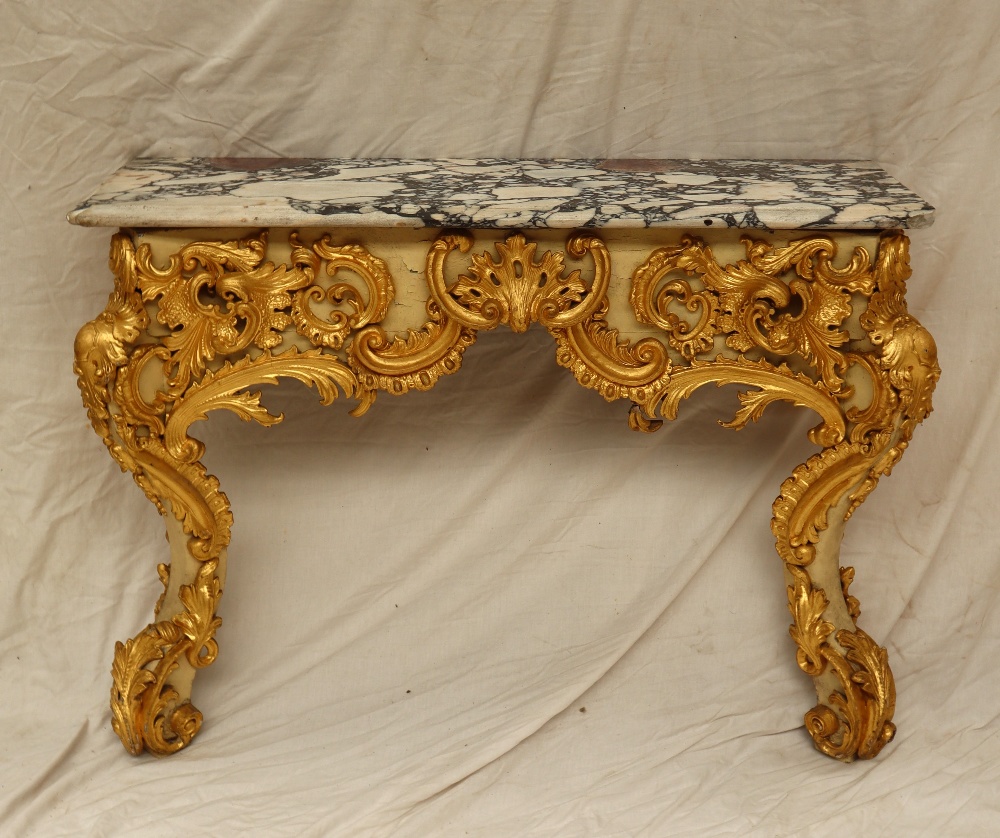 A marble topped console table with a shaped top,