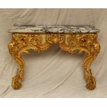 A marble topped console table with a shaped top,