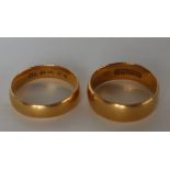 A 22ct yellow gold wedding band, size M, together with another size L, approximately 8.
