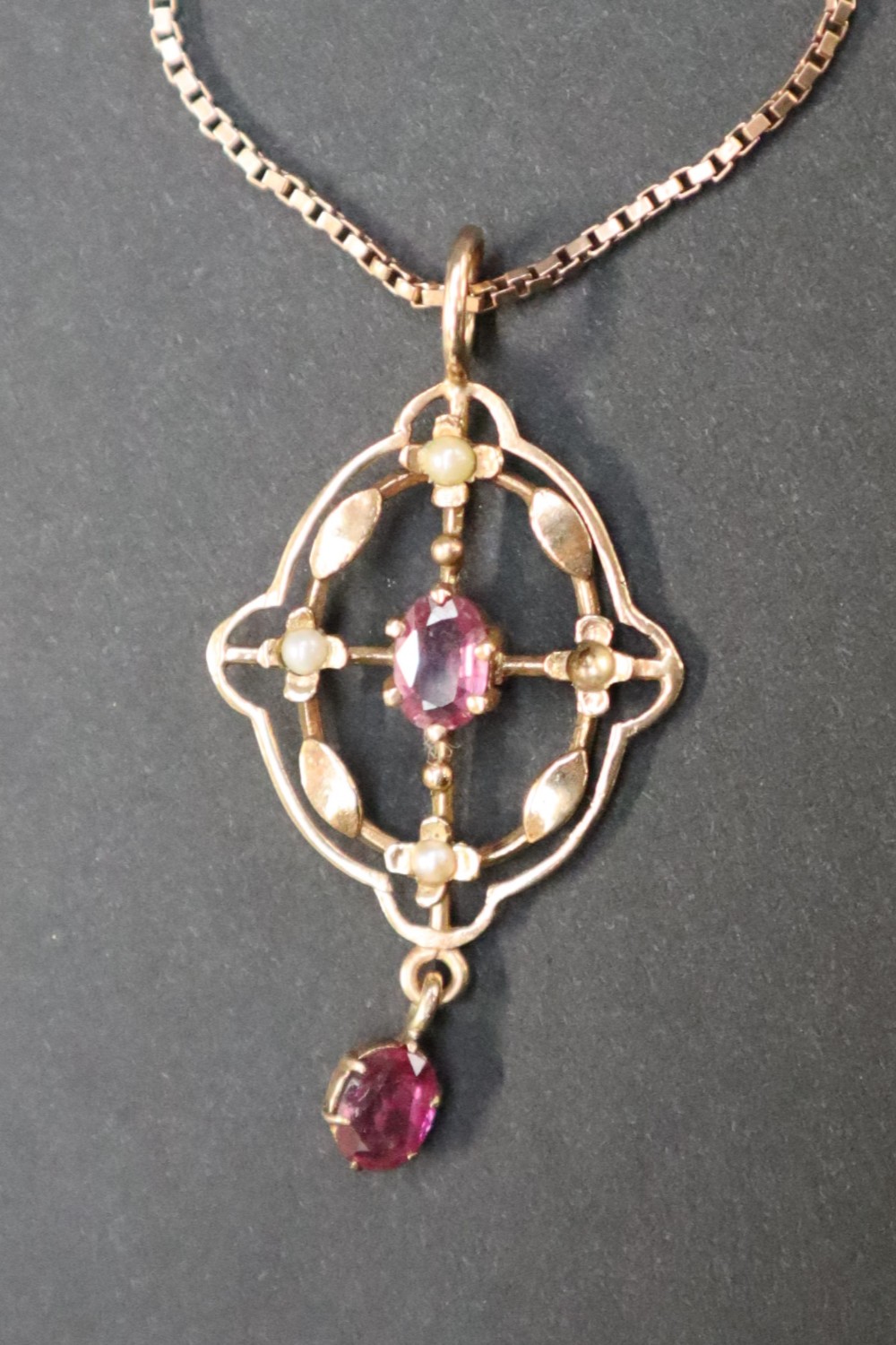 A 9ct gold ruby and seed pearl pendant on a 9ct gold chain together with 9ct gold necklaces, - Image 4 of 4