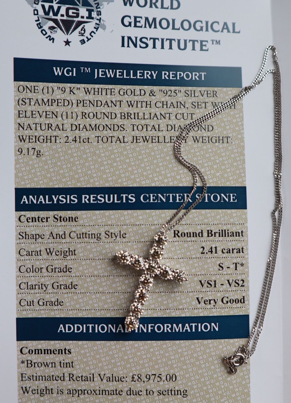 A diamond crucifix set with eleven round brilliant cut diamonds totalling approximately 2.41cts. - Image 3 of 5