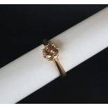 An 18ct yellow gold solitaire diamond ring set with a champagne coloured round brilliant diamond