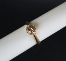 An 18ct yellow gold solitaire diamond ring set with a champagne coloured round brilliant diamond
