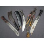 A curved Kukri dagger with a turned wooden metal mounted grip,