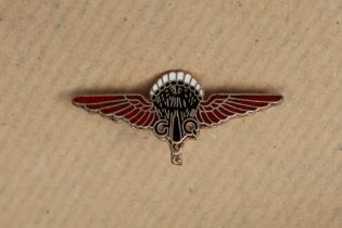 A white metal and enamel decorated Gregory and Quilter Parachute Company badge,