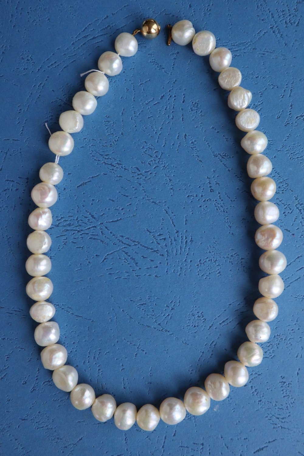 A pearl necklace with forty irregular pearls to a yellow metal ball clasp, 41. - Image 2 of 3