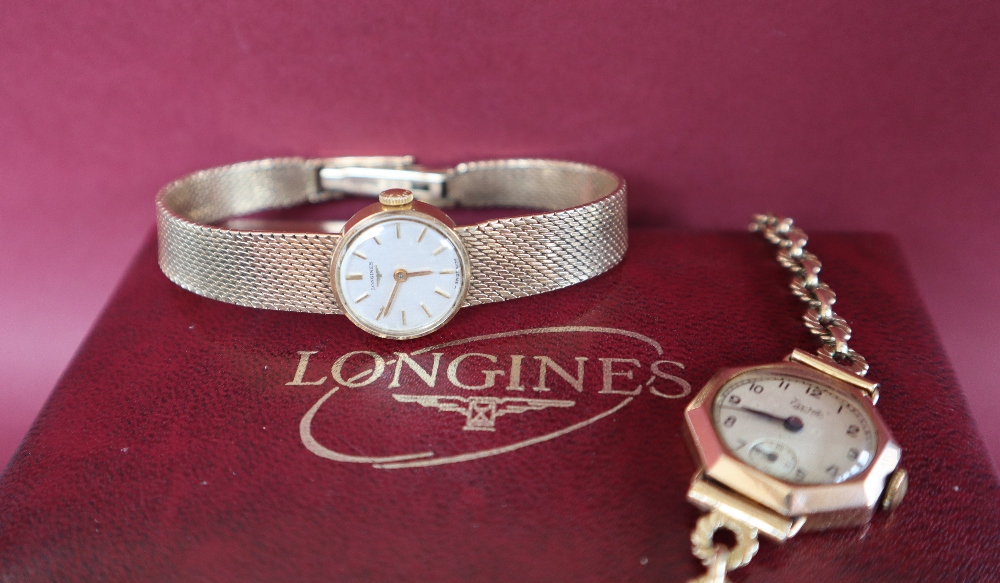 A lady's 9ct gold Longines wristwatch with a circular dial with batons on an integral strap