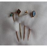 A black opal stick pin to a 9ct yellow gold setting and pin together with a 9ct gold turquoise set