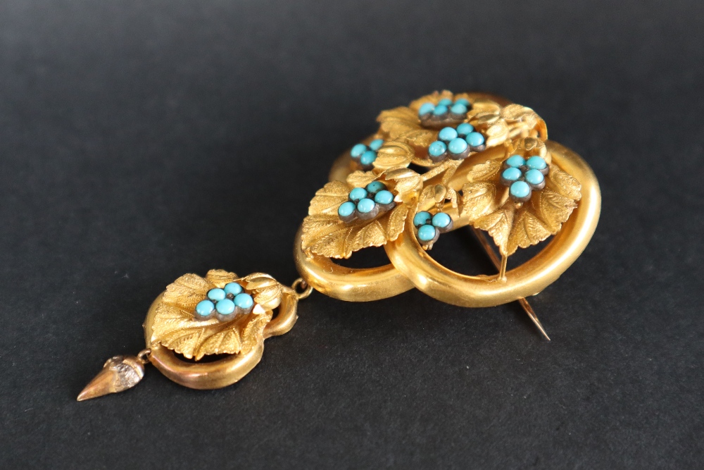 A Victorian yellow metal brooch in the form of three interlaced rings set with vine leaves and - Image 2 of 4