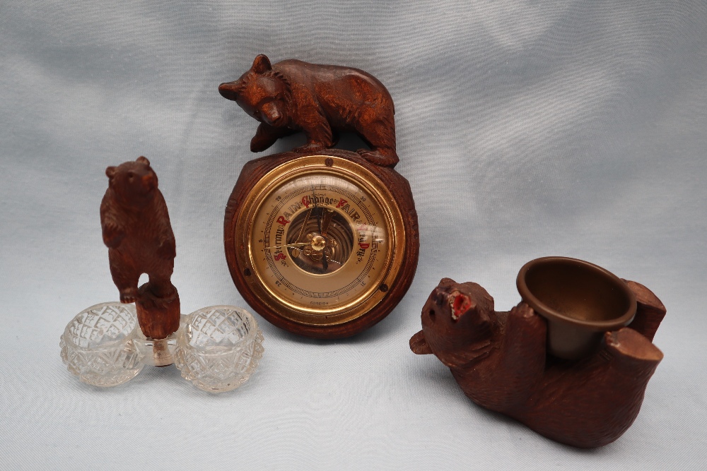 A Black Forest bear barometer together with a carved bear and cut glass table salt and another of a