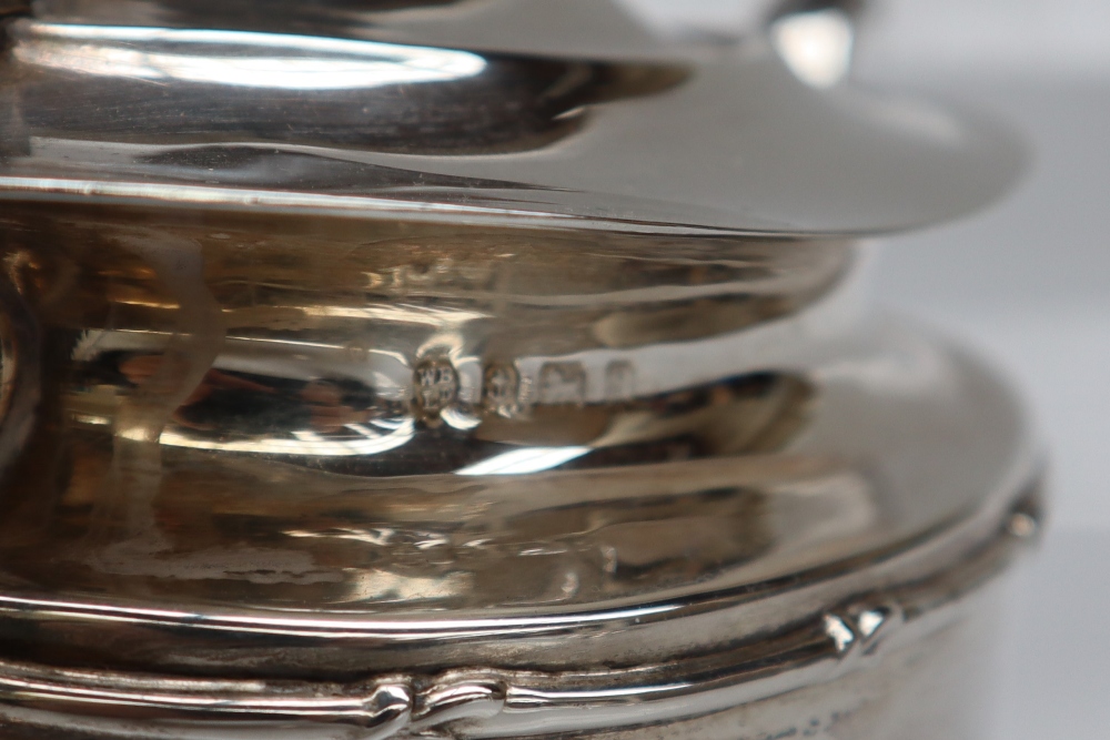 A George V silver three piece tea set, of oval form with swags on a pedestal foot, Birmingham, 1917, - Image 3 of 4