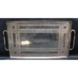 A white metal twin handled tray of rectangular form decorated with scrolls and leaves, overall 42.