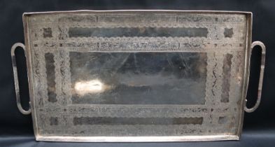 A white metal twin handled tray of rectangular form decorated with scrolls and leaves, overall 42.