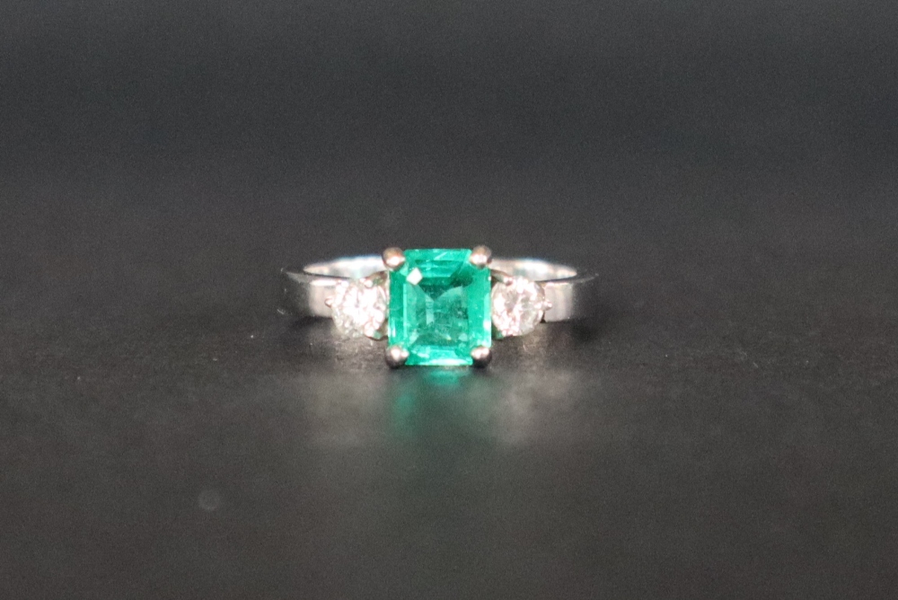 An emerald and diamond ring set with a central emerald cut emerald approximately 6mm x 5mm, - Image 4 of 5