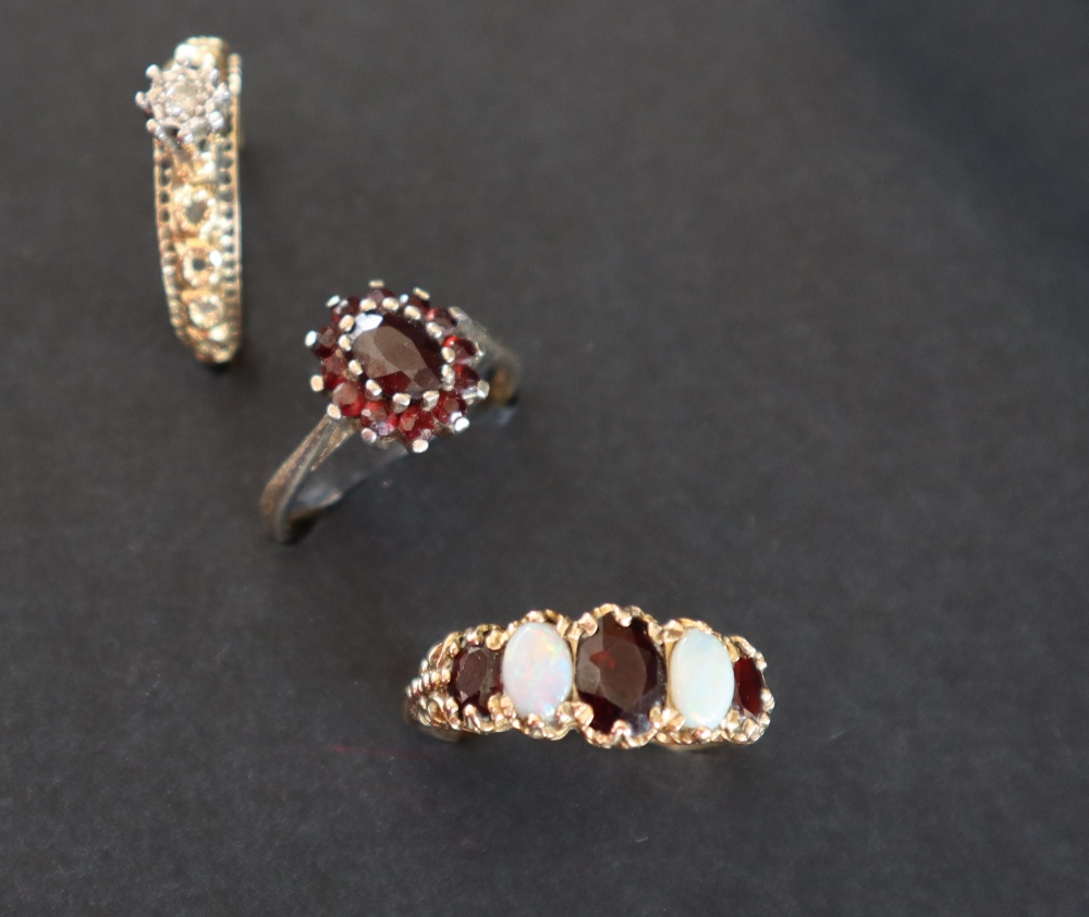 A 9ct gold dress ring set with a line of three garnets and two opals, size P 1/2, - Image 3 of 8