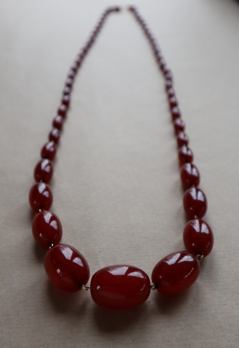 A string of cherry amber / bakelite beads, - Image 2 of 12