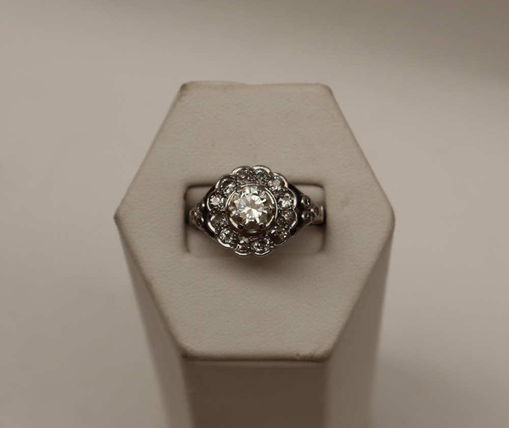 A diamond cluster ring, the central round old cut diamond, approximately 0.