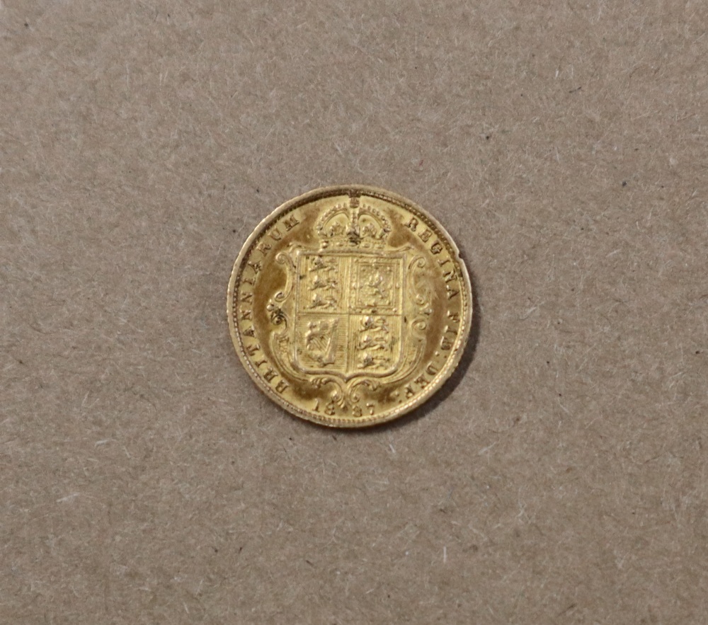 A Victorian shield back gold half sovereign dated 1887