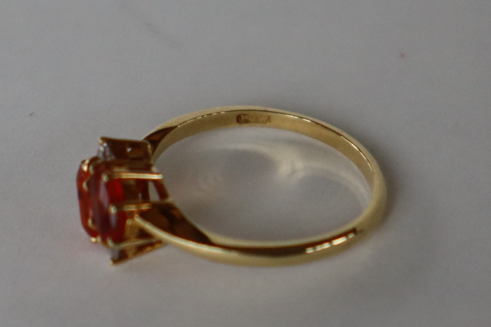 An 18ct gold dress ring set with semi precious orange stones possible Spessartite, and diamonds, - Image 4 of 4