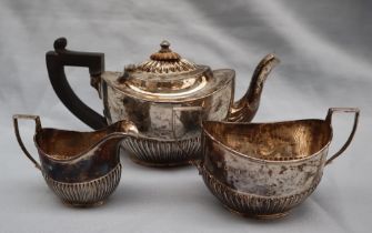 A George V three piece tea set, of small size with a half gadrooned body, London, 1911,