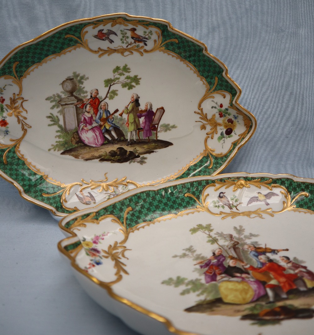 A pair of Meissen oval leaf shaped dishes painted with vignettes of a song bird,
