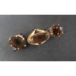 A 9ct gold dress ring set with an oval faceted smoky quartz, size m,