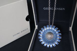 A Georg Jensen blue daisy brooch / pendant,