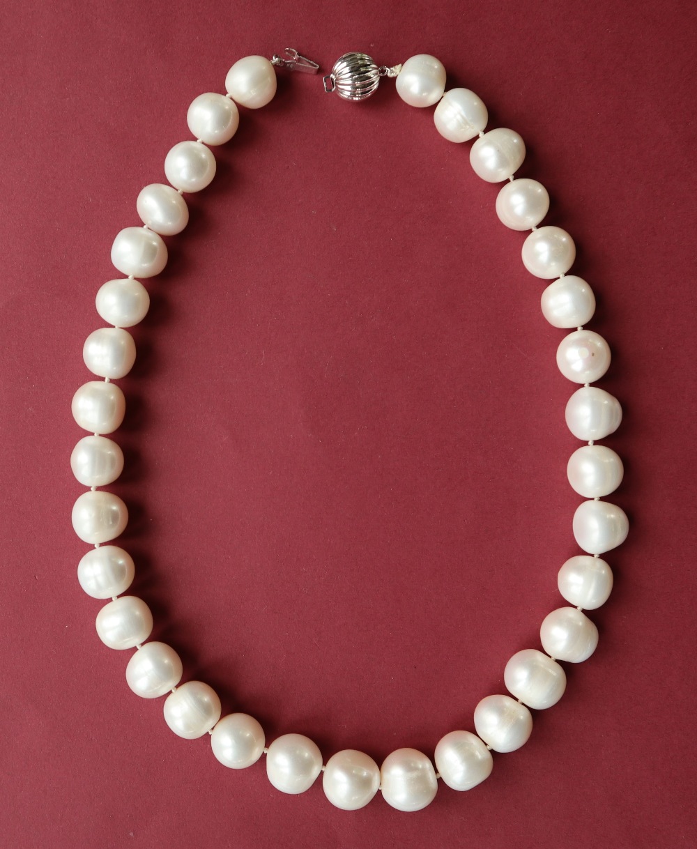 A cultured pearl necklace set with large barrel shaped pearls to a 9ct white gold concertina style